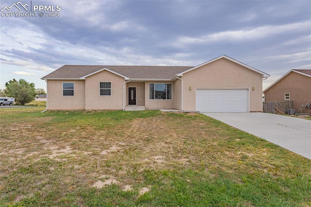 single story home with central AC, a front lawn, and a garage