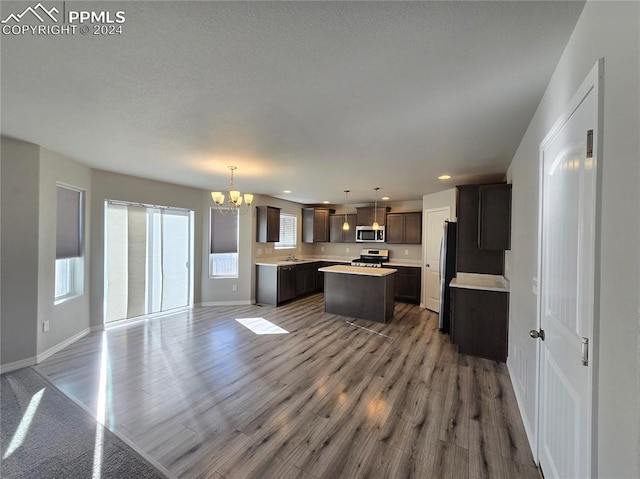 kitchen featuring hardwood / wood-style floors, a kitchen island, and a wealth of natural light