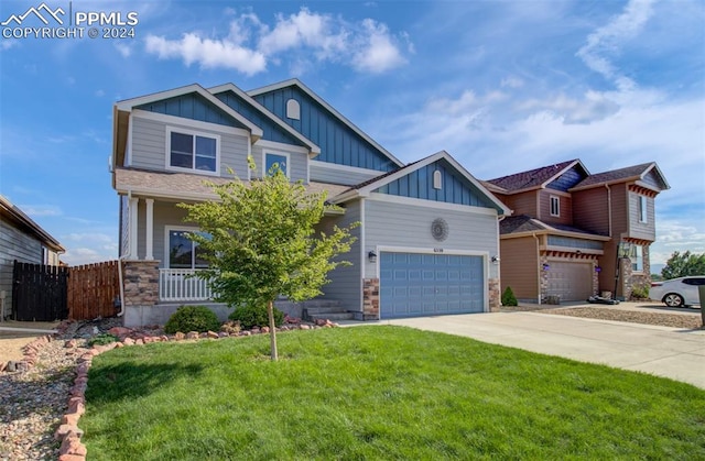 craftsman-style house featuring a front yard and covered porch