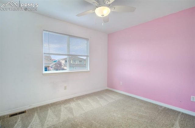 carpeted empty room with ceiling fan