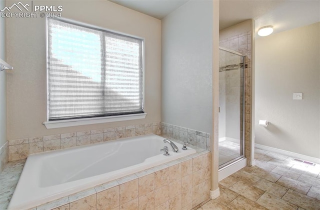 bathroom with shower with separate bathtub