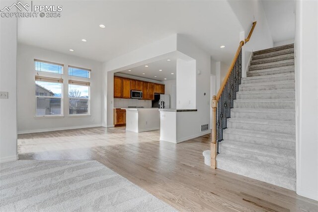 unfurnished living room with light wood-type flooring