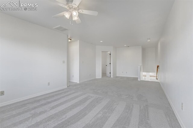 empty room with light carpet and ceiling fan