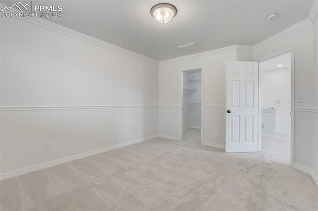 carpeted spare room with crown molding