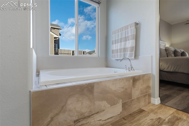 bathroom featuring a relaxing tiled tub