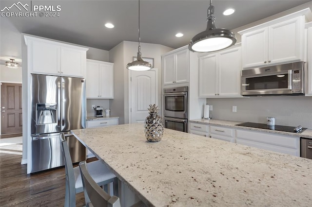 kitchen featuring white cabinets, dark hardwood / wood-style flooring, hanging light fixtures, and appliances with stainless steel finishes