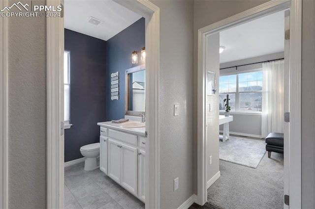 bathroom featuring vanity and toilet