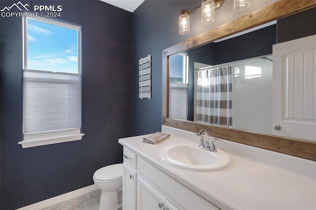 bathroom with tile patterned flooring, vanity, toilet, and a shower with shower curtain