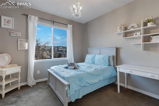 bedroom with a chandelier and dark carpet