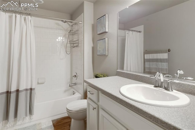 full bathroom with shower / tub combo with curtain, vanity, wood-type flooring, and toilet