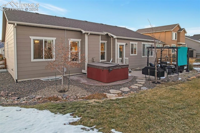 snow covered property featuring a playground, a yard, a patio, and a hot tub