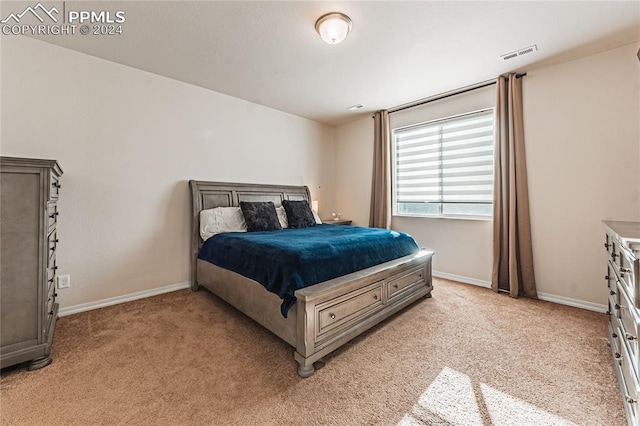 bedroom with light colored carpet