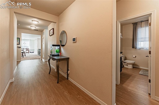 hall with light hardwood / wood-style flooring