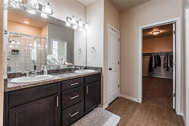 bathroom featuring hardwood / wood-style floors, vanity, and an enclosed shower