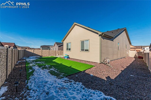 rear view of house featuring a yard