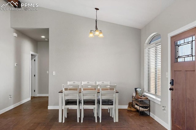 dining room featuring a chandelier, dark wood-type flooring, and vaulted ceiling