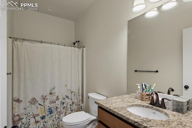 full bathroom with vanity, toilet, and shower / tub combo with curtain