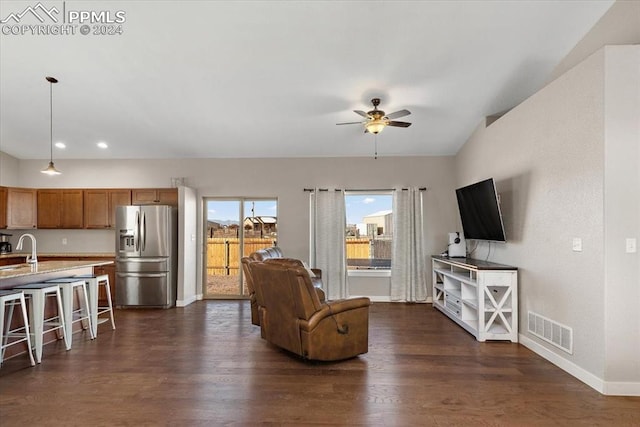 living room featuring dark hardwood / wood-style flooring, ceiling fan, lofted ceiling, and sink