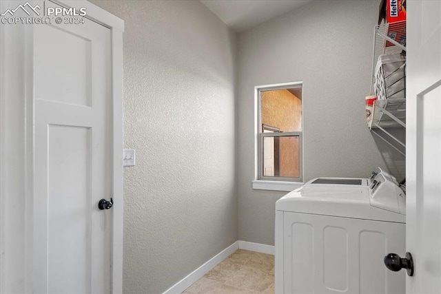 laundry area with light tile patterned floors