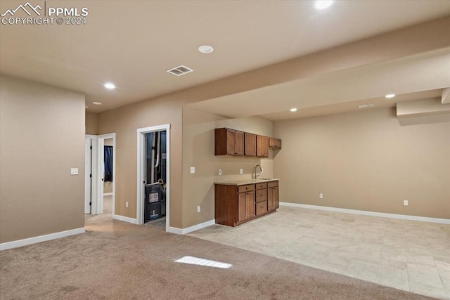 interior space featuring sink and light carpet