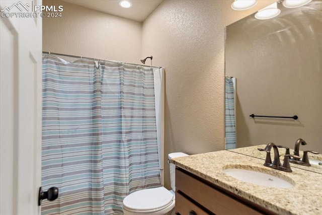 full bathroom featuring shower / bath combination with curtain, vanity, and toilet