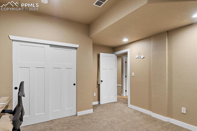 interior space featuring light colored carpet