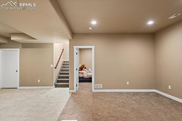 basement featuring light carpet