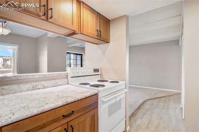 kitchen featuring light carpet and white range with electric stovetop