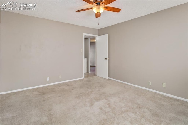 empty room featuring light colored carpet and ceiling fan