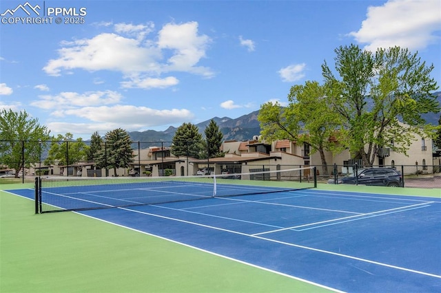 view of tennis court with basketball court and a mountain view