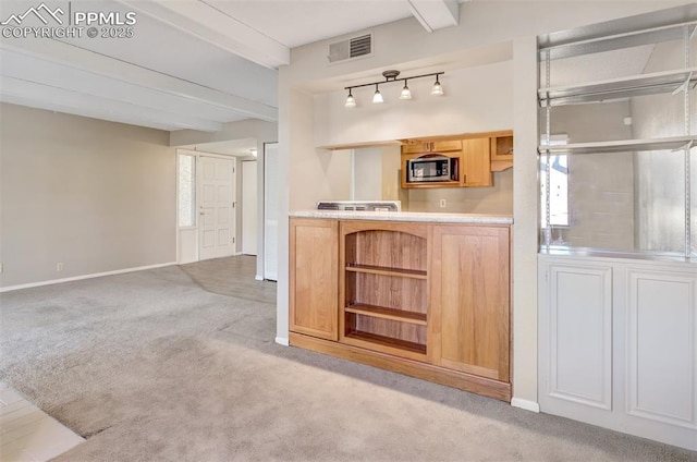 bar featuring light brown cabinetry, light colored carpet, and beam ceiling