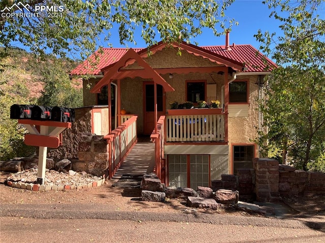 view of front of property featuring a tiled roof and stucco siding