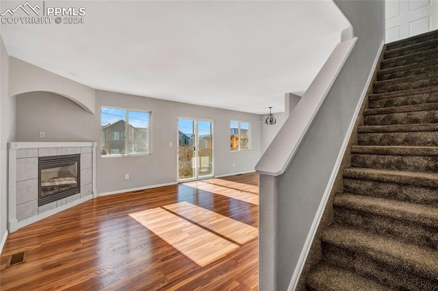 unfurnished living room featuring a fireplace and hardwood / wood-style floors