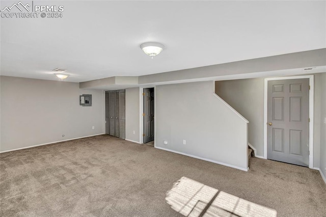 basement featuring light carpet