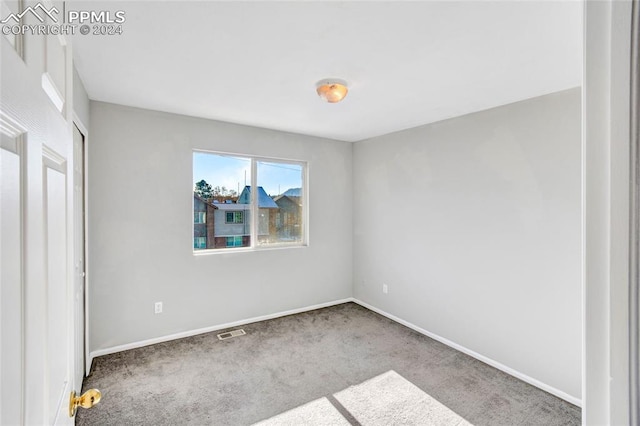 unfurnished bedroom with light colored carpet