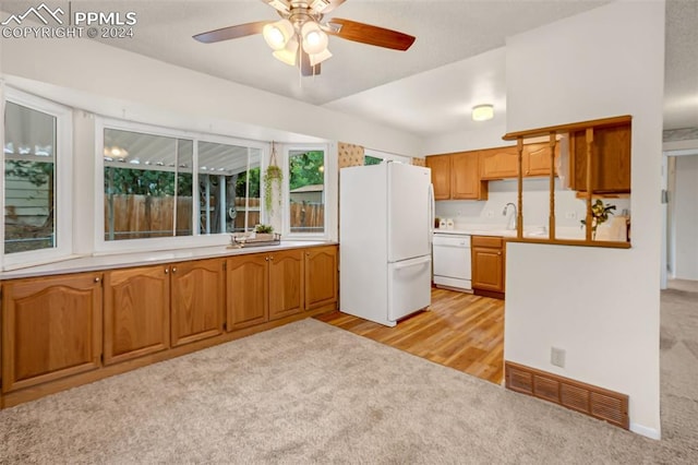 kitchen with ceiling fan, sink, light colored carpet, and white appliances