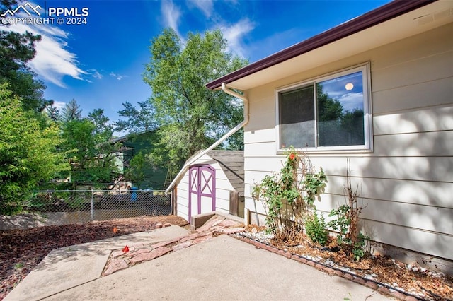 exterior space with a patio and a storage shed