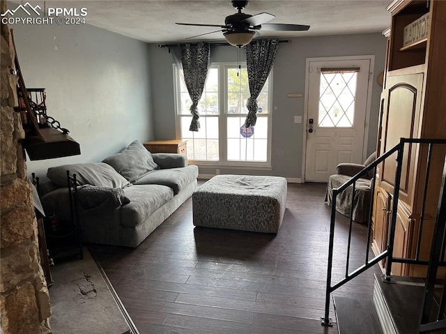 living room with ceiling fan, plenty of natural light, and dark hardwood / wood-style floors