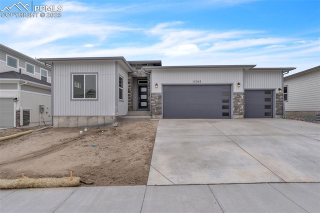 5265 Gansevoort Dr, Colorado Springs, CO 80927 - view of front facade with a garage, driveway, and stone siding