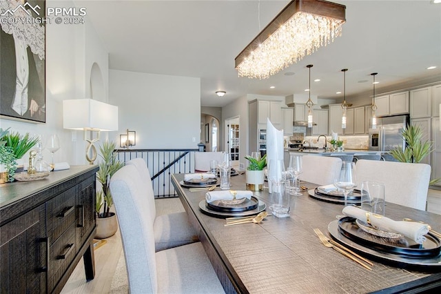 dining space featuring a notable chandelier and sink