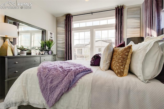 bedroom featuring carpet and multiple windows