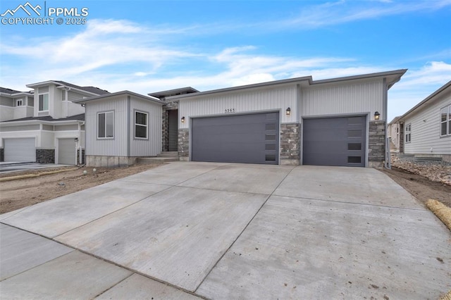 5265 Gansevoort Dr, Colorado Springs, CO 80927 - view of front of property with an attached garage, driveway, and stone siding