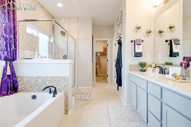 bathroom with tile patterned flooring, vanity, and independent shower and bath