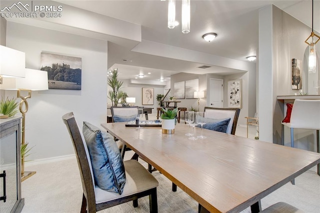 dining area featuring light colored carpet