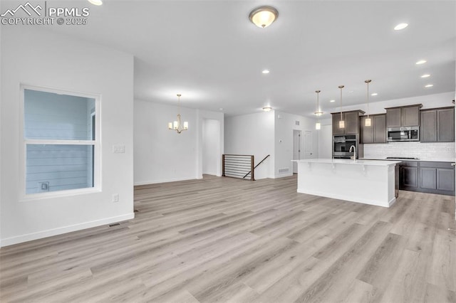 5265 Gansevoort Dr, Colorado Springs, CO 80927 - unfurnished living room featuring a chandelier, recessed lighting, and light wood-style floors