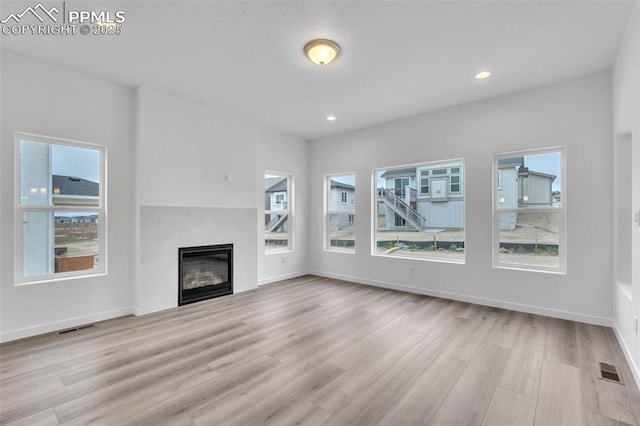 5265 Gansevoort Dr, Colorado Springs, CO 80927 - unfurnished living room with wood finished floors, a fireplace, and recessed lighting