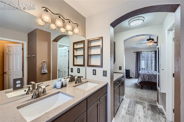 bathroom with hardwood / wood-style floors, ceiling fan, and vanity