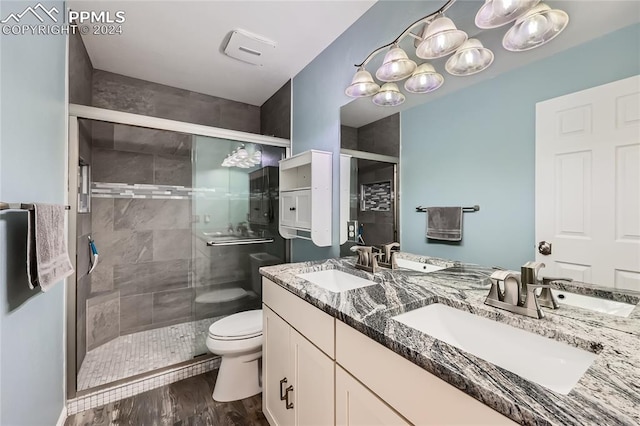 bathroom featuring vanity, hardwood / wood-style flooring, toilet, and walk in shower