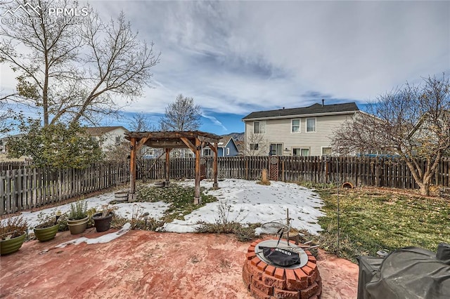 yard covered in snow featuring a fire pit, a pergola, and a patio