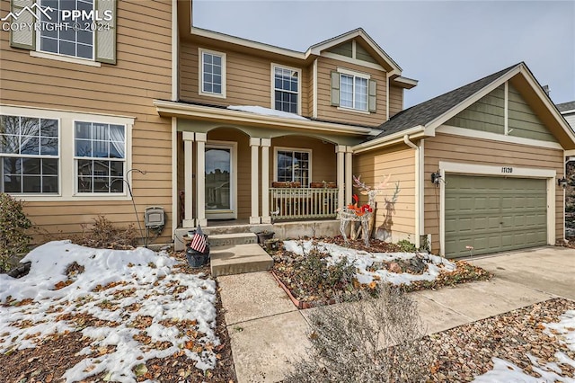 view of front of home featuring a porch and a garage